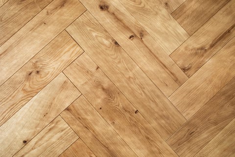 Natural rustic wooden oak parquet flooring background. Rustic floor pattern for interior and indoor home design top view.