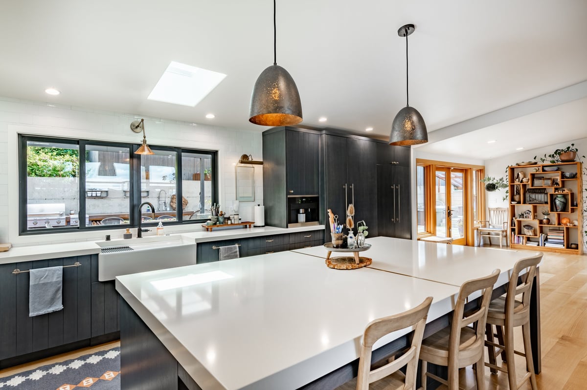 Modern kitchen with dark cabinetry and marble island